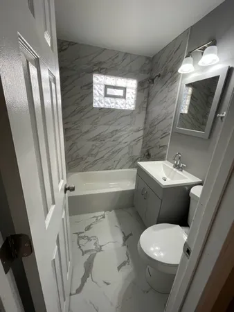 a bathroom with a toilet a sink and bathtub