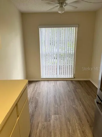 an empty room with wooden floor and a window