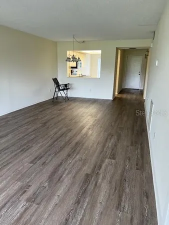 a view of a room with wooden floor and a table