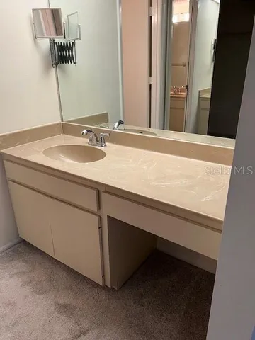 a white toilet sitting next to a bathroom sink