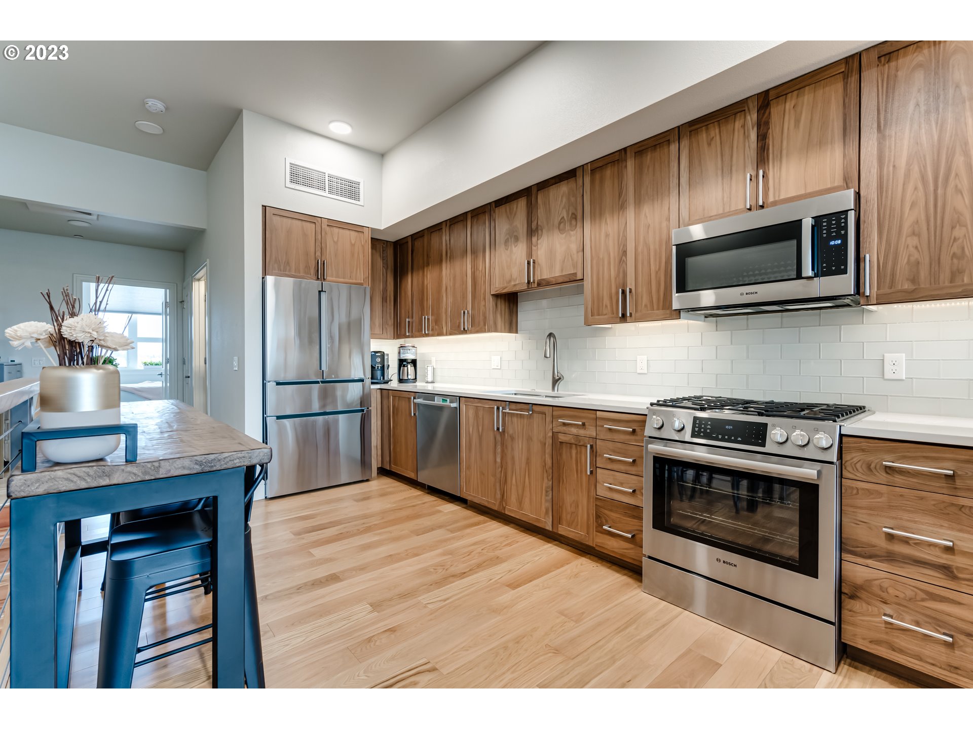 1600 Pearl Street Eugene, OR 97401 - Photo 5 of 21 a kitchen with stainless steel appliances a stove a sink a microwave and wooden cabinets