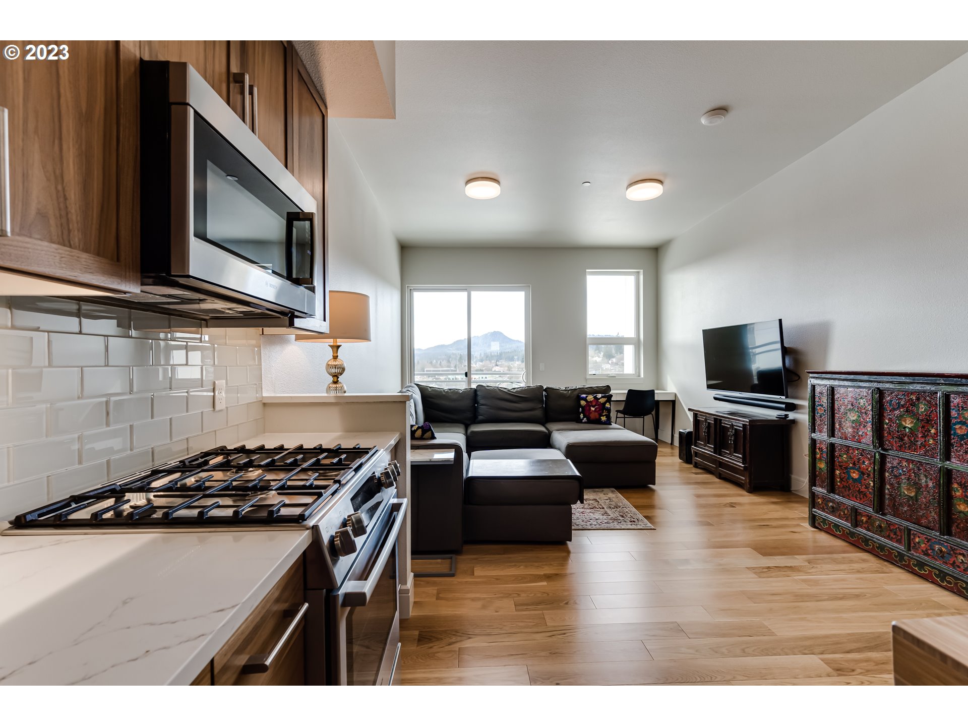1600 Pearl Street Eugene, OR 97401 - Photo 6 of 21 a kitchen with stainless steel appliances a stove a microwave a sink a stove and cabinets
