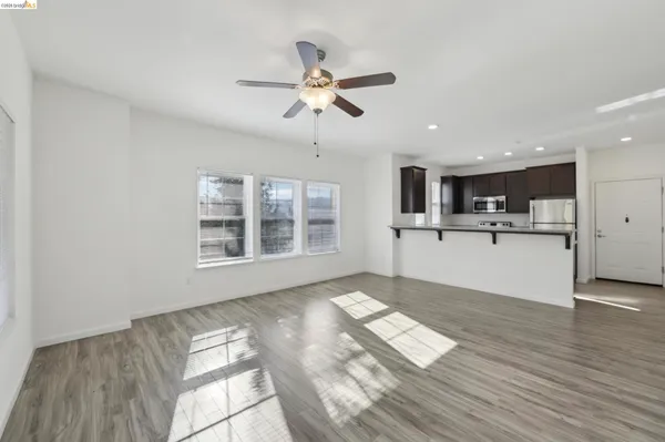 a living room with furniture and kitchen view