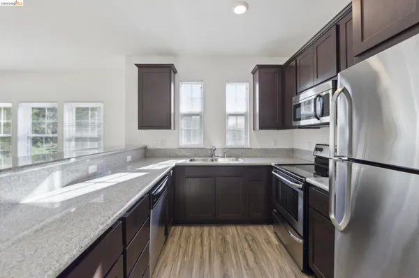 a kitchen with cabinets and stainless steel appliances