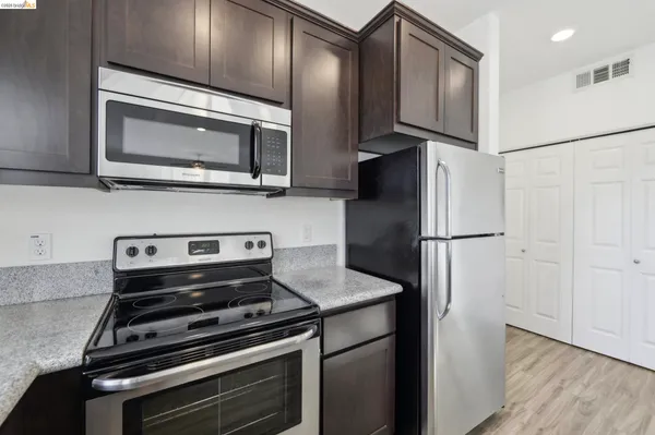 a kitchen with granite countertop a sink and a window