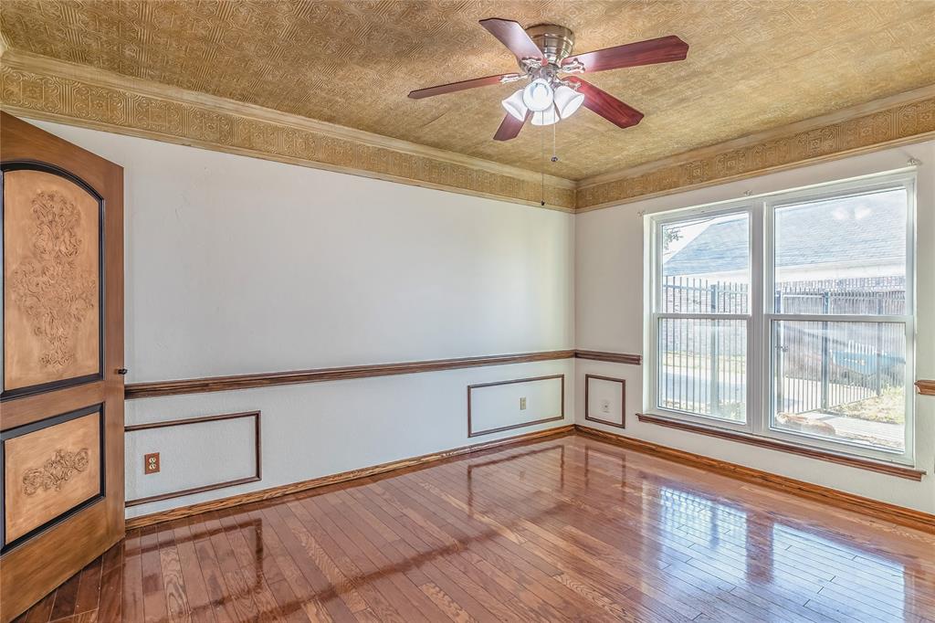 716 Bridget Way Hurst, TX 76054 - Photo 11 of 33 Unfurnished room with hardwood / wood-style floors, a ceiling fan, and crown molding