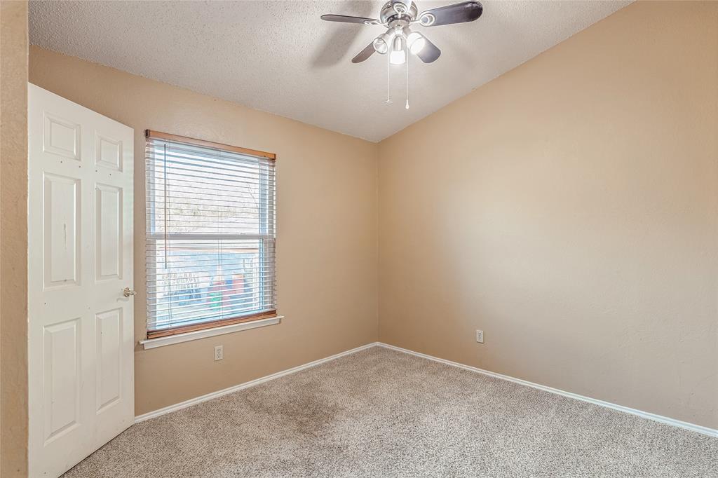 716 Bridget Way Hurst, TX 76054 - Photo 28 of 33 Carpeted spare room with ceiling fan and a textured ceiling