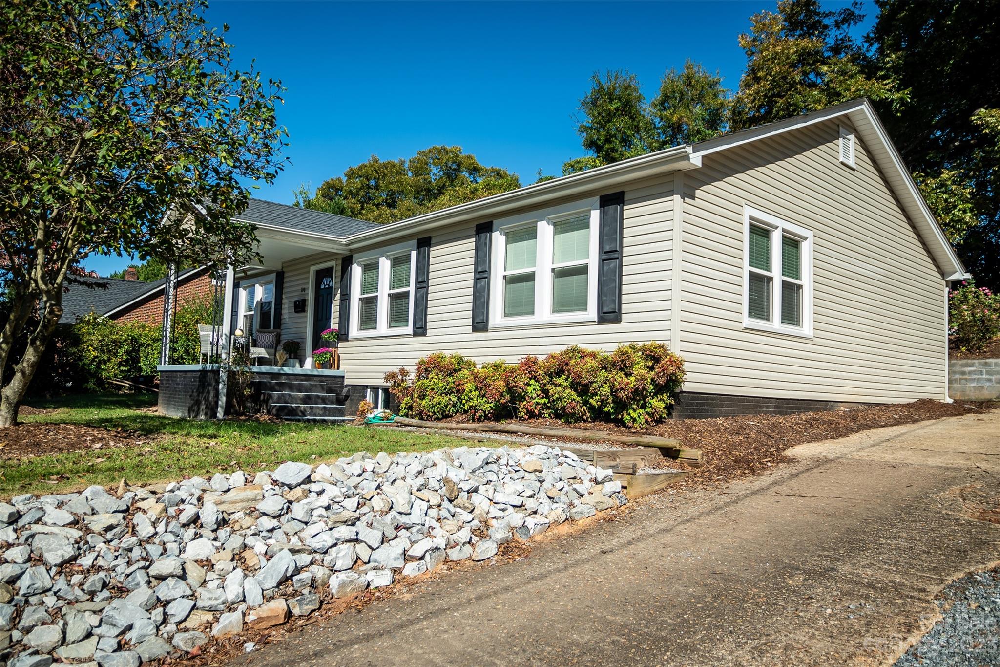 a front view of a house with a garden