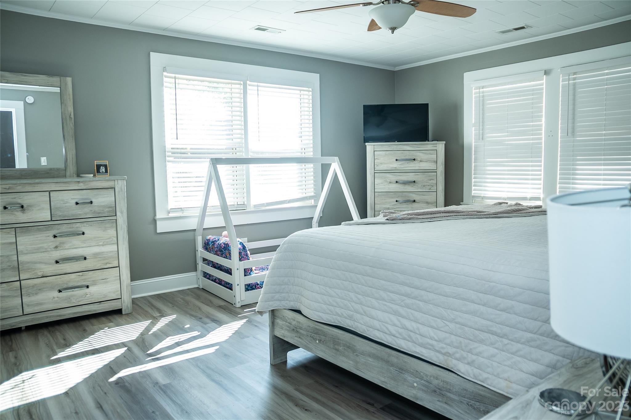 106 Cascade Street Morganton, NC 28655 - Photo 15 of 36 a bedroom with a bed and a flat tv screen on dresser