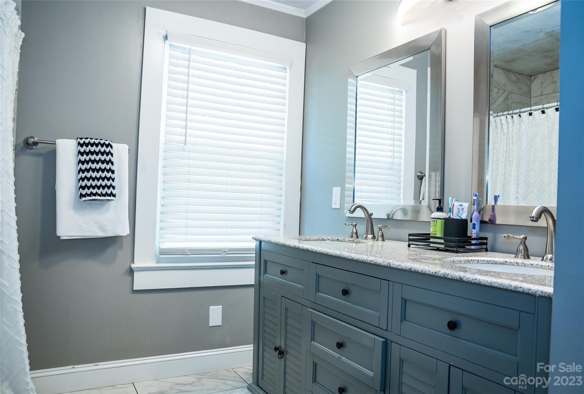 106 Cascade Street Morganton, NC 28655 - Photo 18 of 36 a bathroom with a granite countertop sink and a window