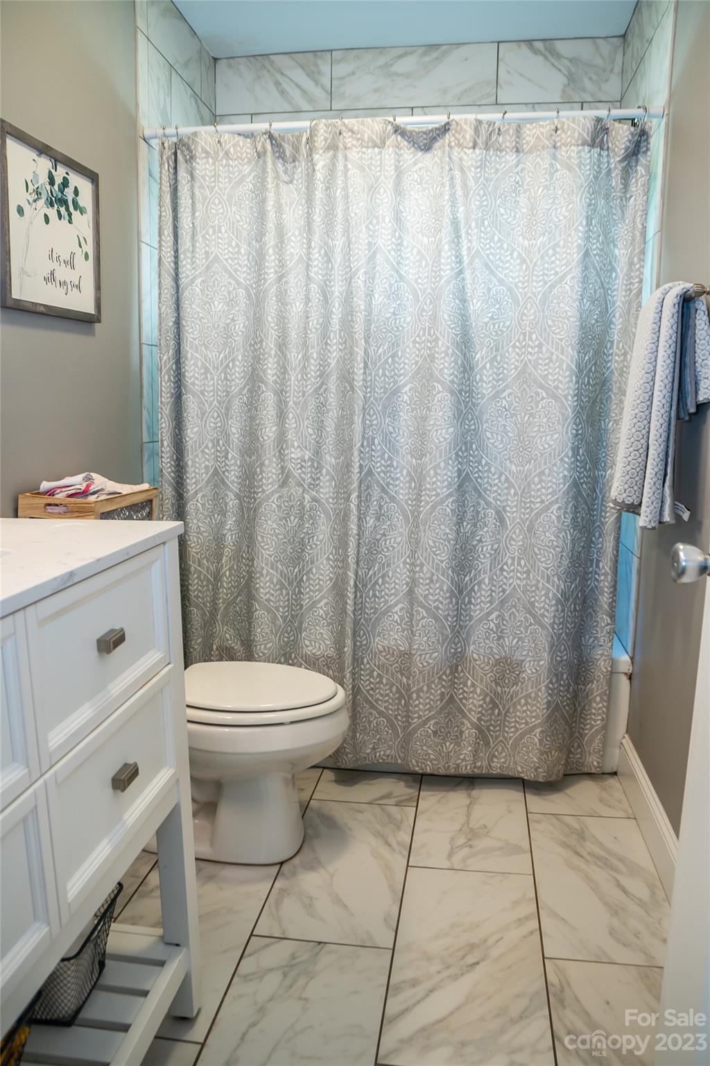 106 Cascade Street Morganton, NC 28655 - Photo 26 of 36 a bathroom with a toilet and a shower curtain