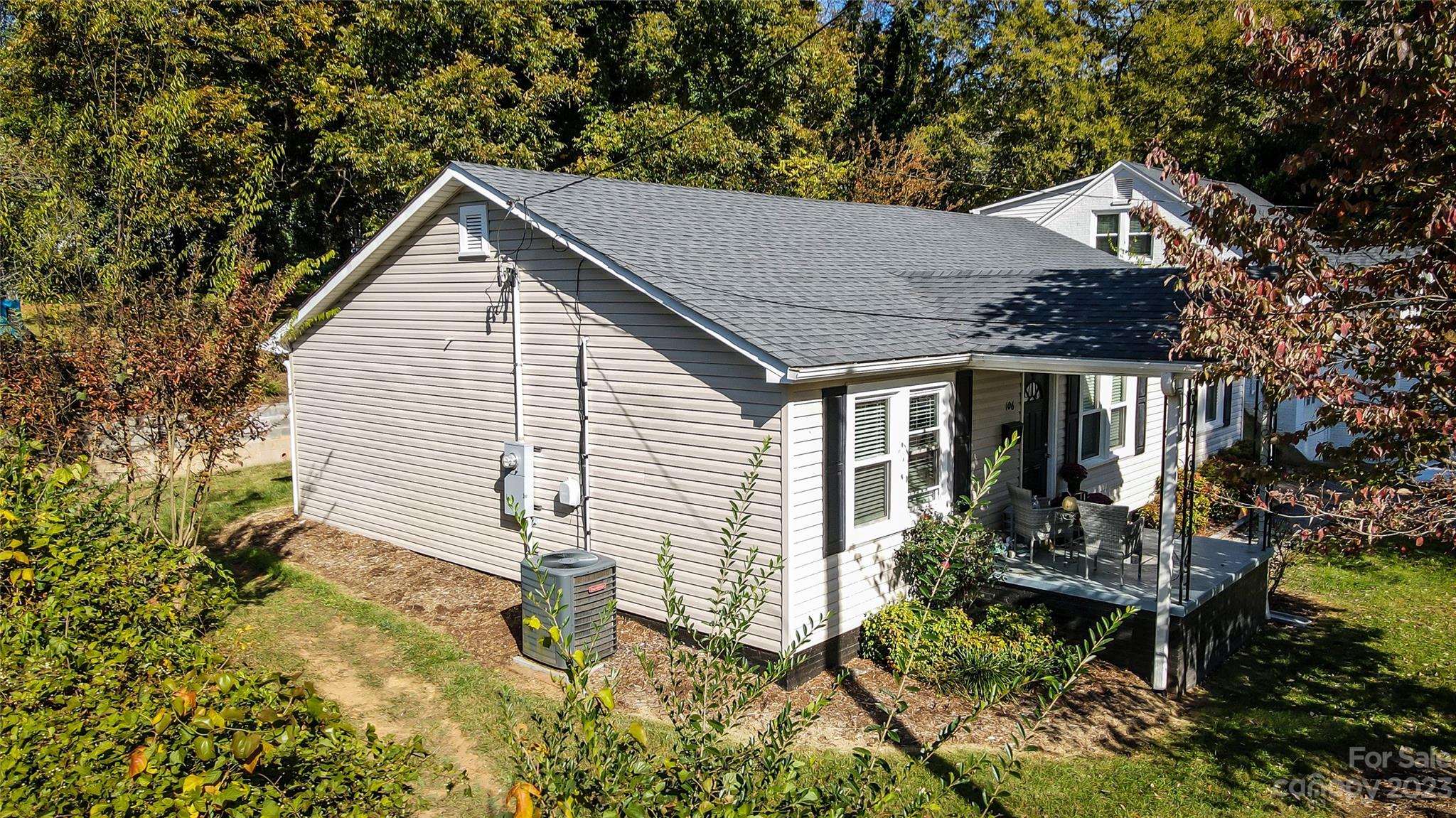 106 Cascade Street Morganton, NC 28655 - Photo 4 of 36 a view of house with a yard and table and chairs in patio