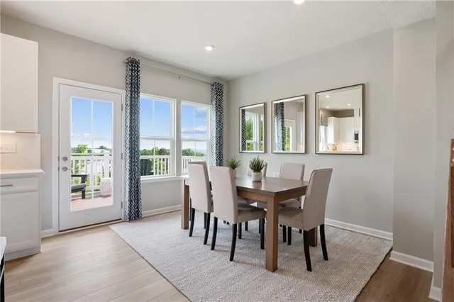 a view of a dining room with furniture and a window