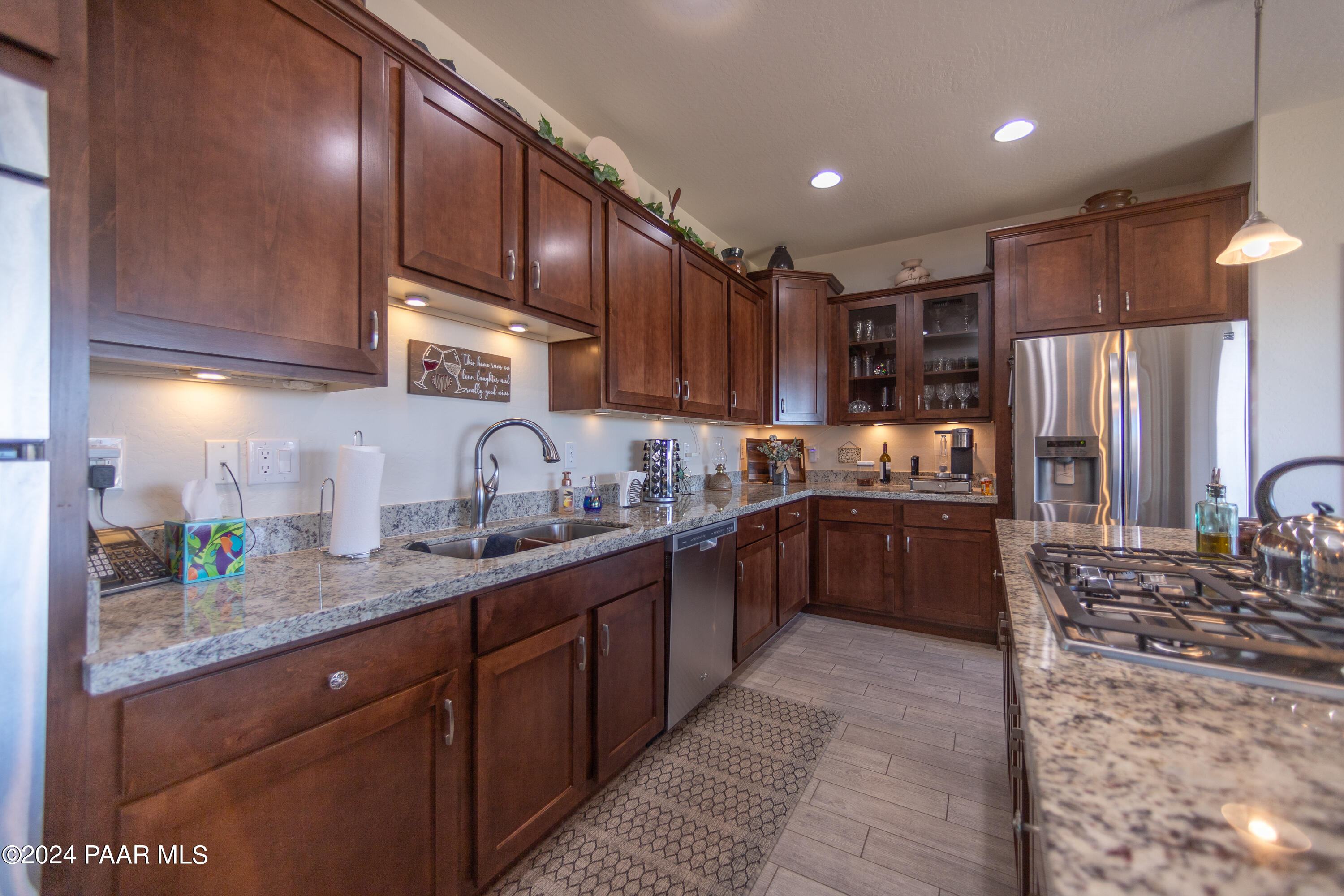 1109 Stack Rock Road Prescott Valley, AZ 86314 - Photo 15 of 91 a kitchen with granite countertop stainless steel appliances and wooden cabinets