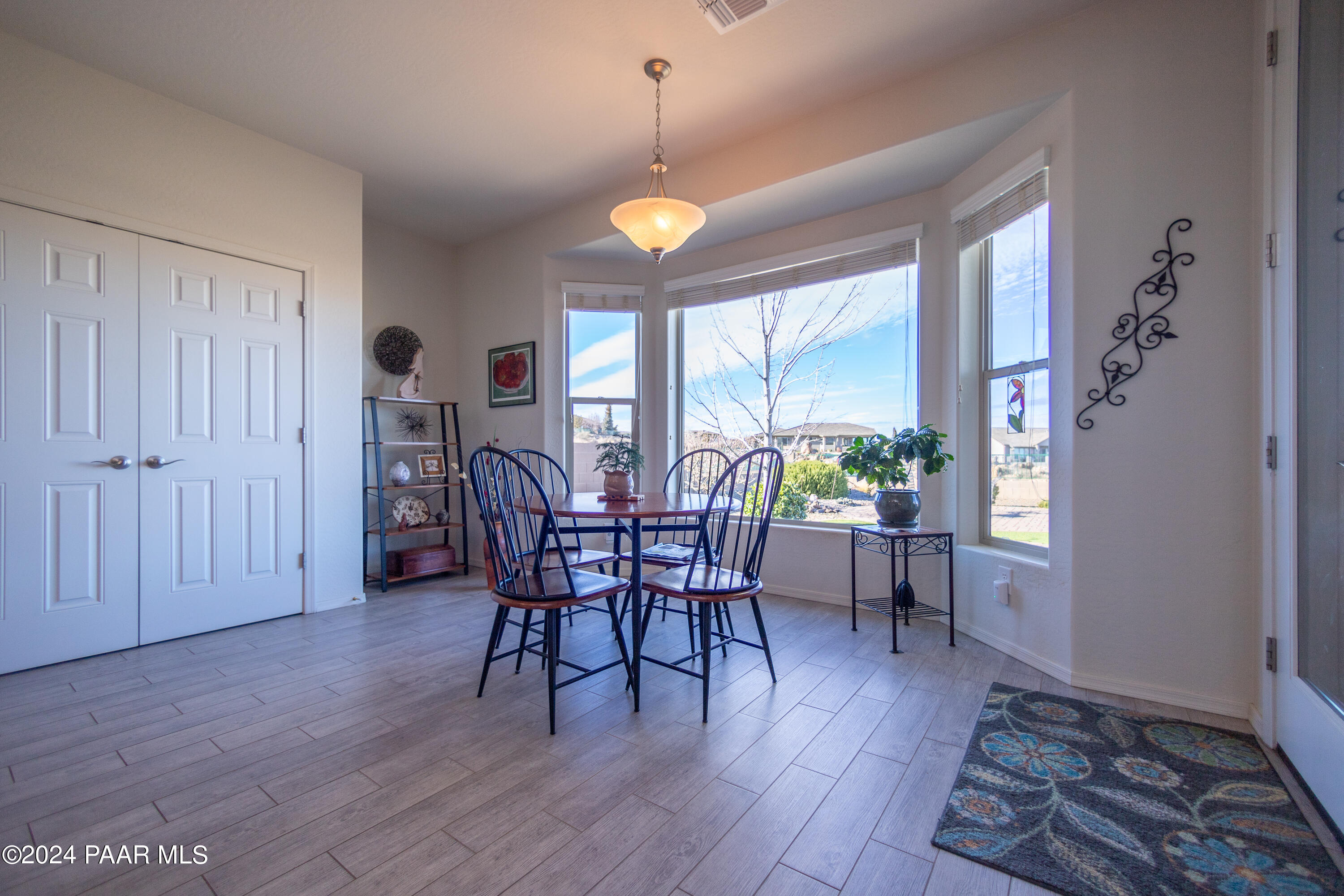1109 Stack Rock Road Prescott Valley, AZ 86314 - Photo 18 of 91 a view of a dining room with furniture window and wooden floor