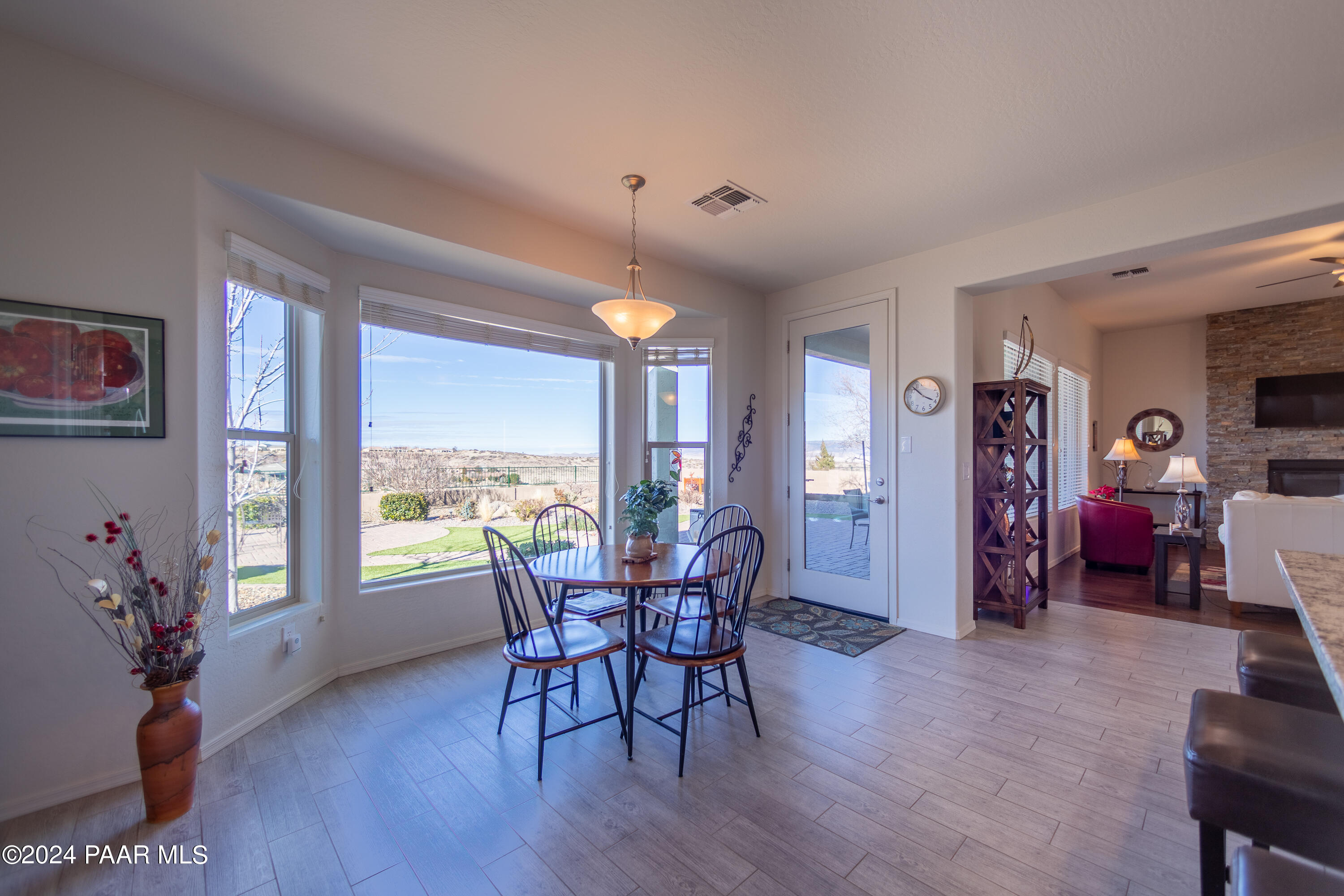 1109 Stack Rock Road Prescott Valley, AZ 86314 - Photo 19 of 91 a view of a dining room with furniture window and wooden floor