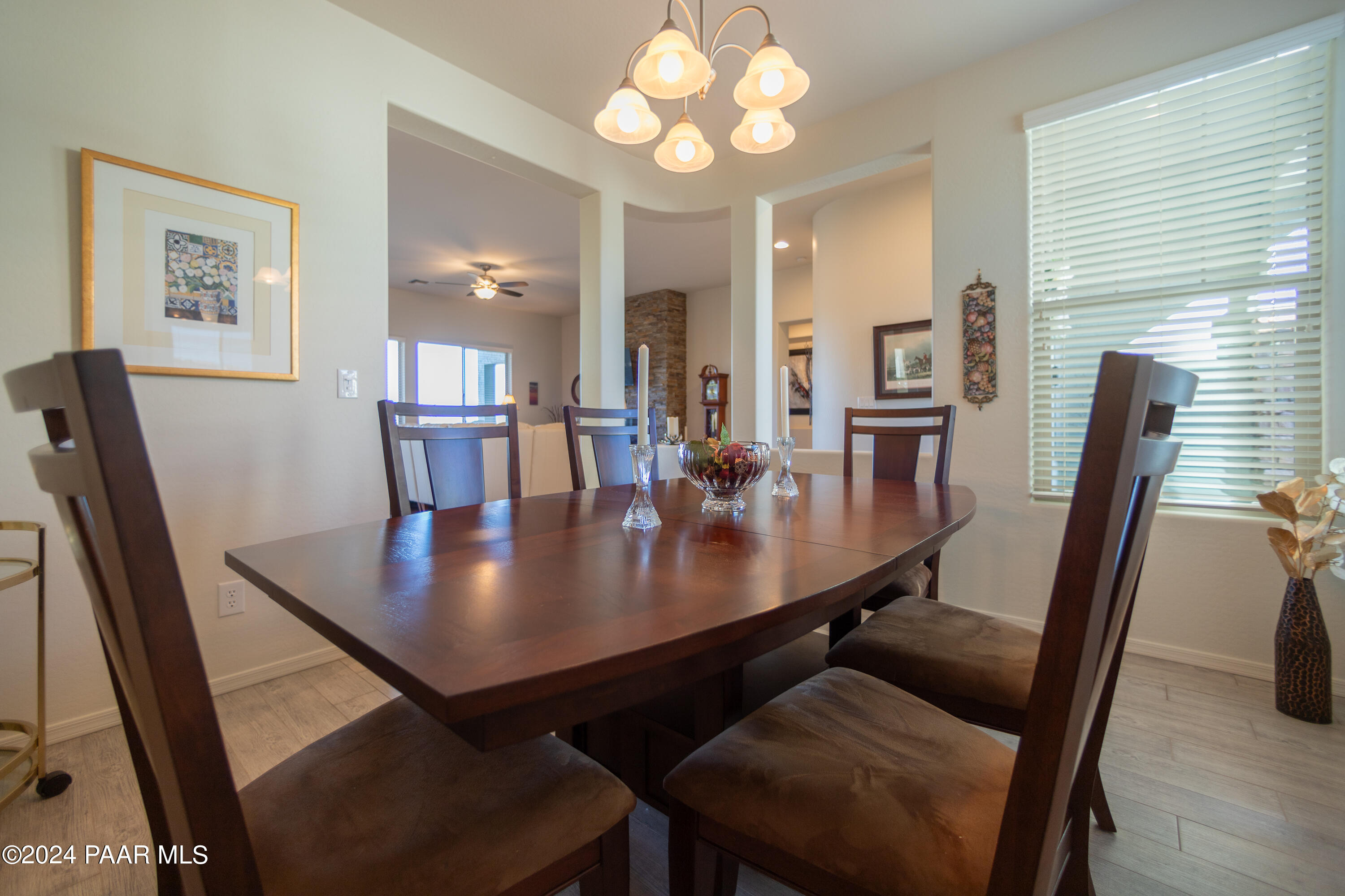 1109 Stack Rock Road Prescott Valley, AZ 86314 - Photo 23 of 91 a view of a dining room with furniture and wooden floor