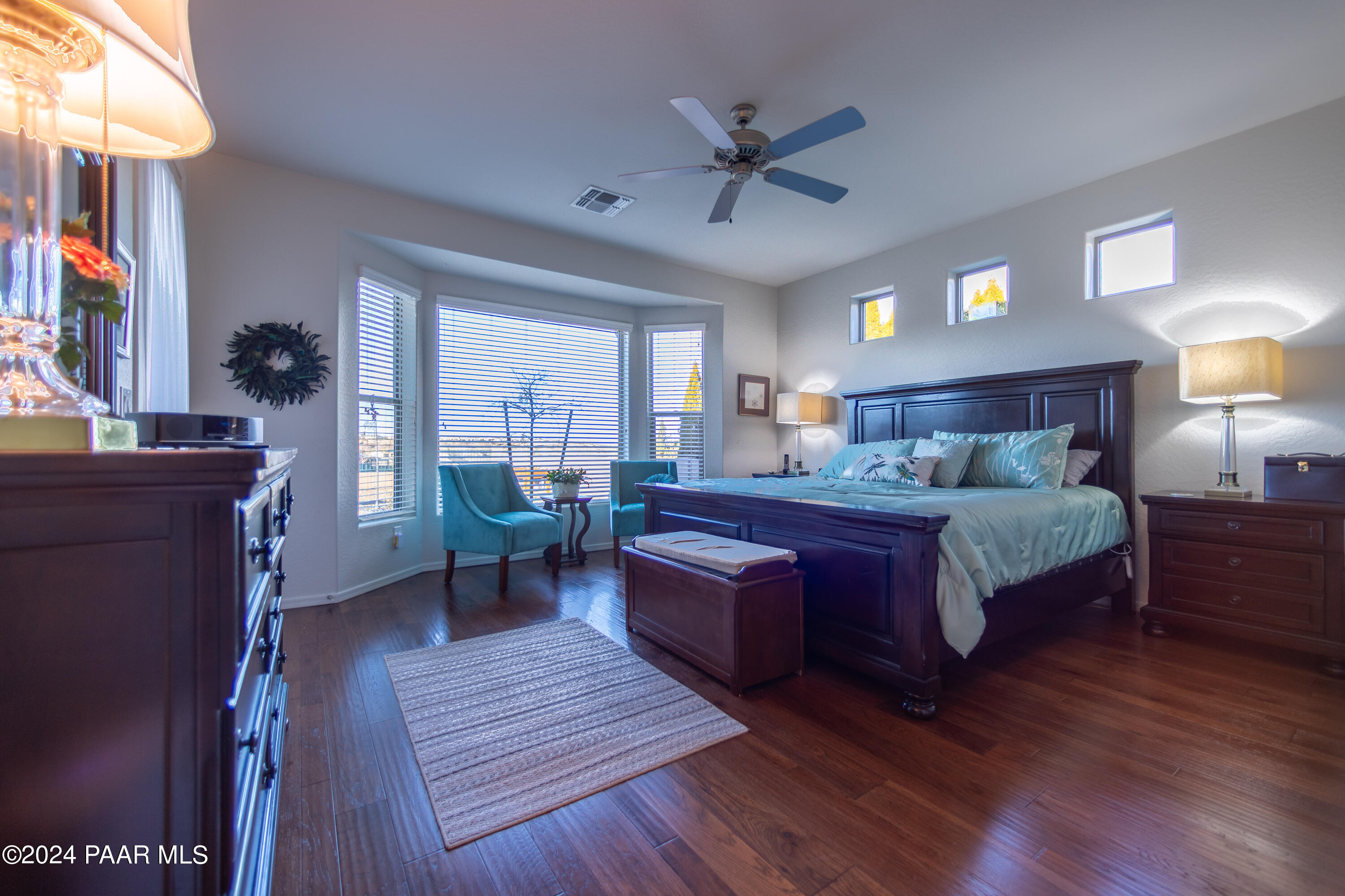 1109 Stack Rock Road Prescott Valley, AZ 86314 - Photo 47 of 91 a bedroom with a bed and wooden floor