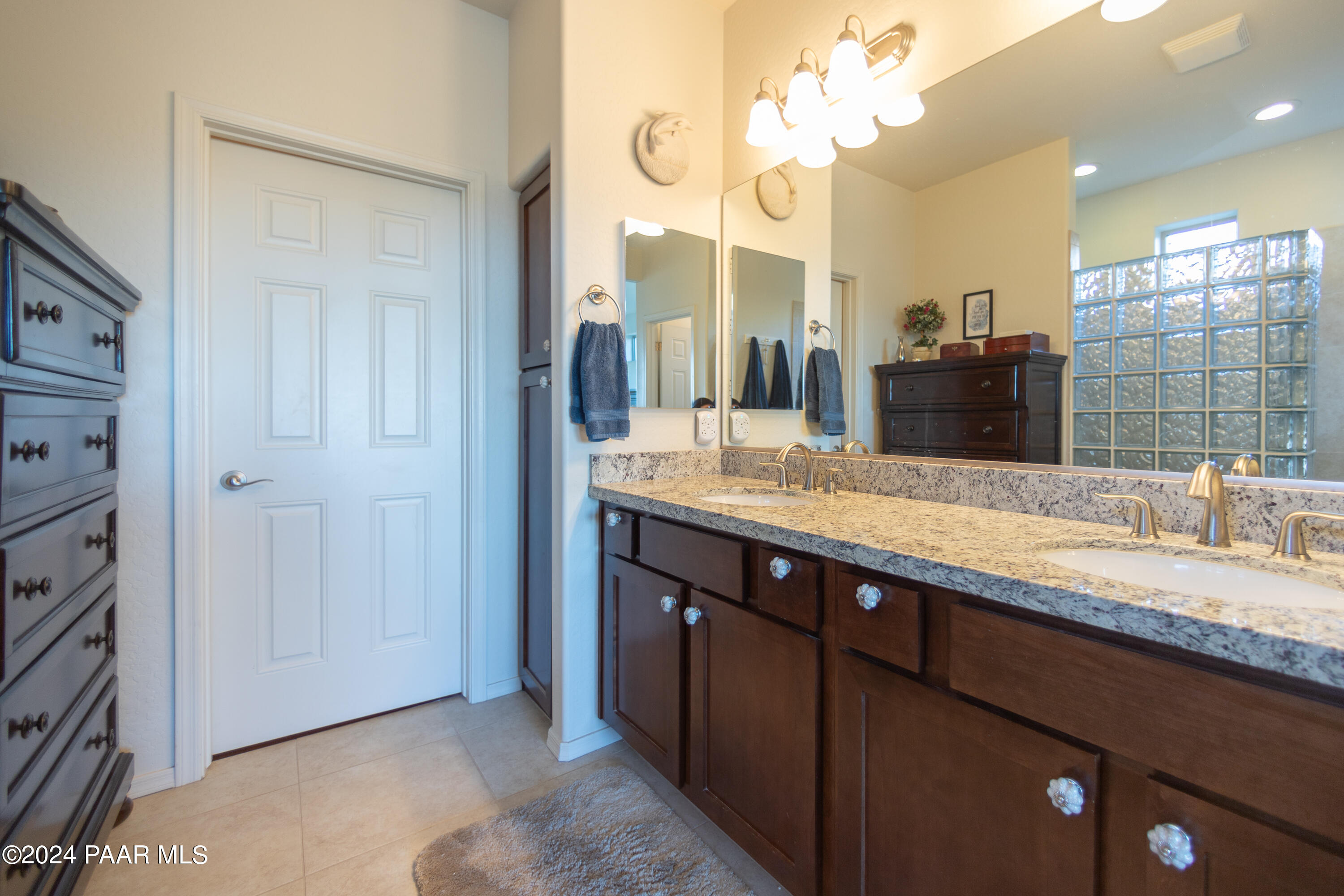1109 Stack Rock Road Prescott Valley, AZ 86314 - Photo 49 of 91 a bathroom with a granite countertop double vanity sink and a mirror