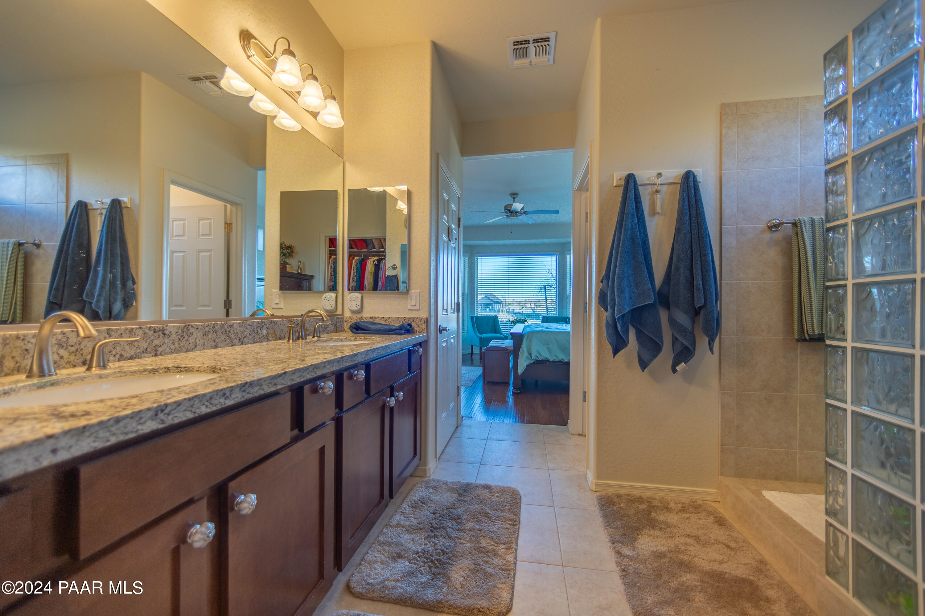 1109 Stack Rock Road Prescott Valley, AZ 86314 - Photo 52 of 91 a spacious bathroom with a double vanity sink a mirror and a shower