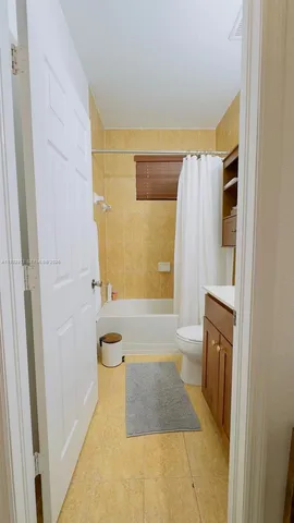a bathroom with a granite countertop shower a sink and a bathtub