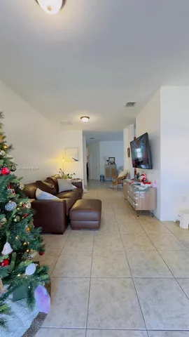 a living room with furniture and flowers