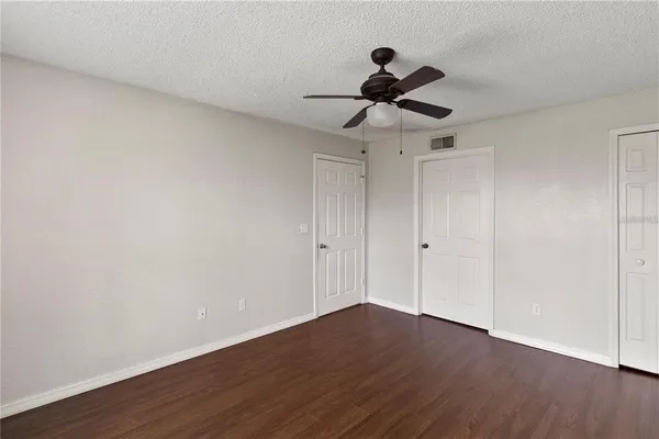 a view of an empty room and wooden floor
