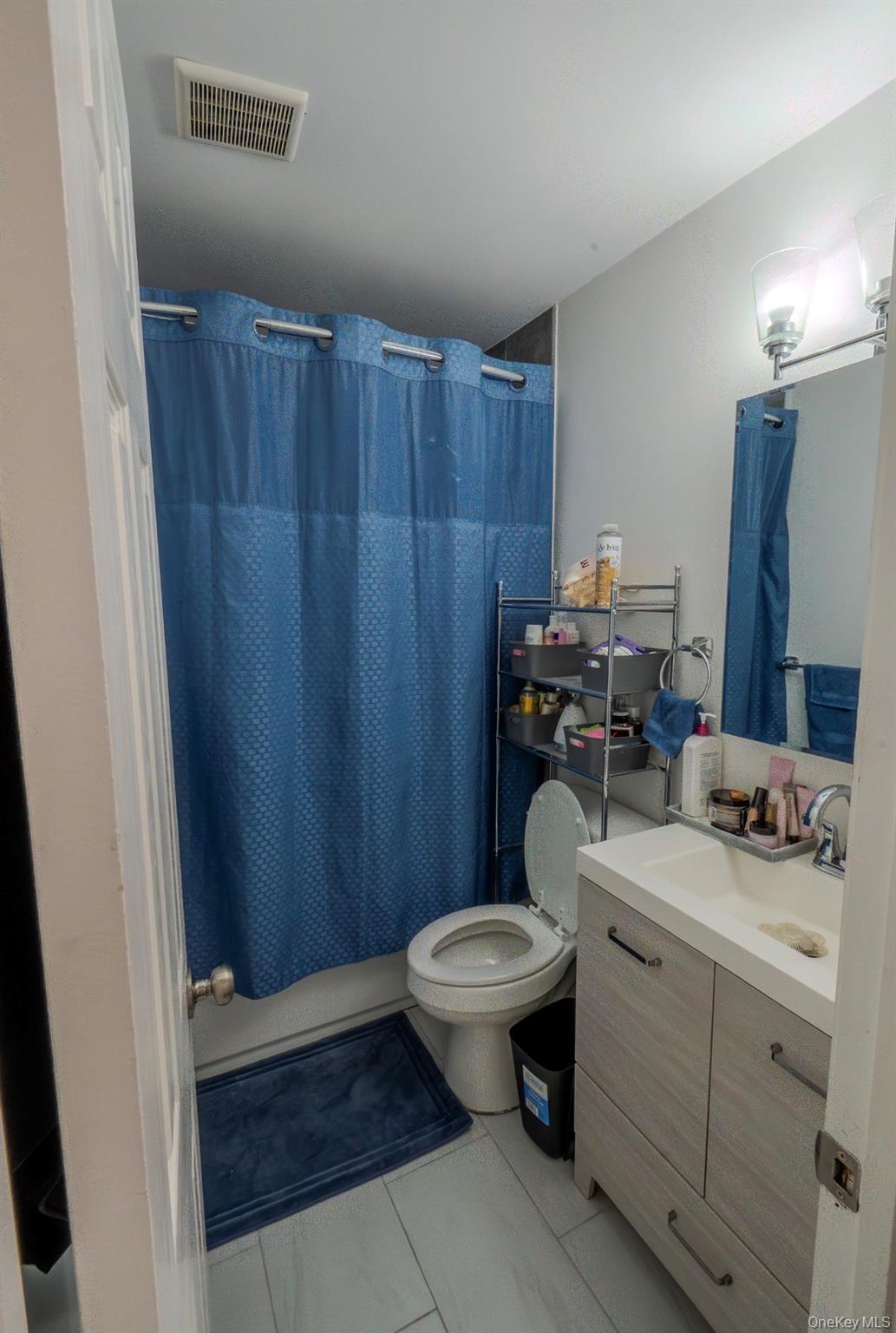 276 Temple Hill Road, Unit 704 New Windsor, NY 12553 - Photo 11 of 18 a bathroom with a sink a toilet a mirror and vanity