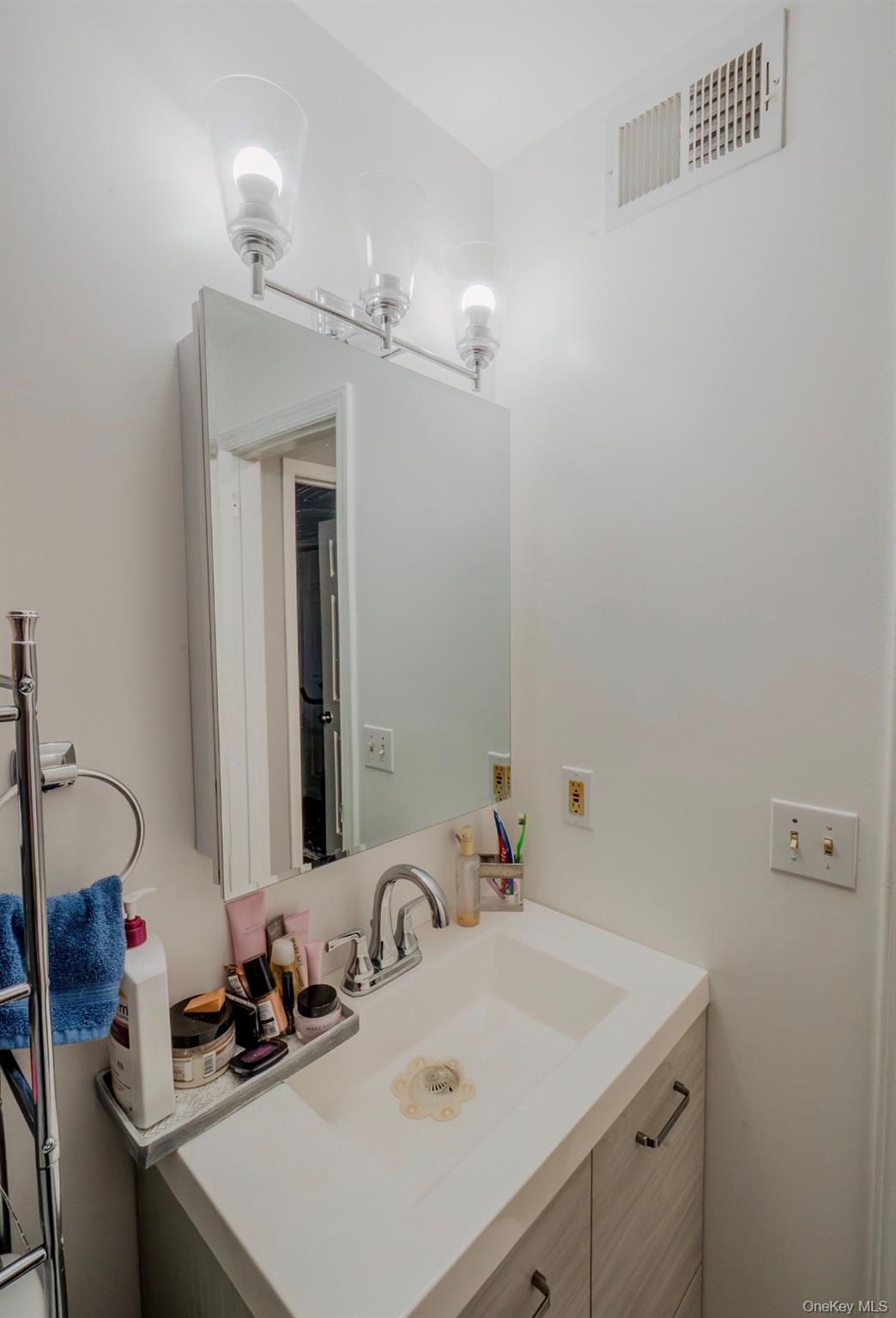 276 Temple Hill Road, Unit 704 New Windsor, NY 12553 - Photo 12 of 18 a bathroom with a sink vanity and a mirror