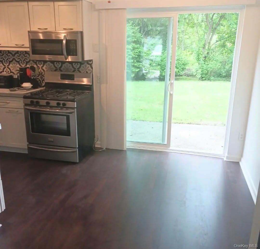 276 Temple Hill Road, Unit 704 New Windsor, NY 12553 - Photo 2 of 18 a kitchen with a stove and a microwave