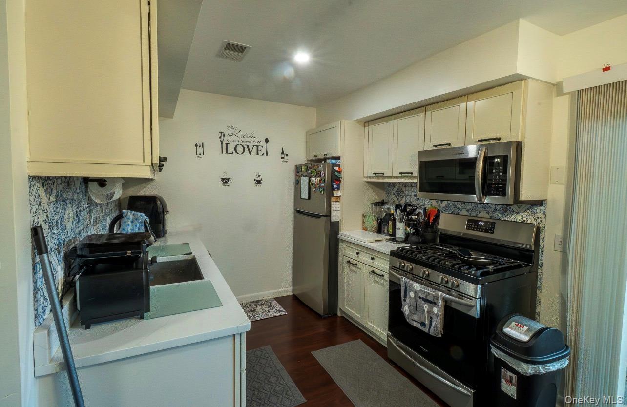 276 Temple Hill Road, Unit 704 New Windsor, NY 12553 - Photo 3 of 18 a kitchen with a stove and a microwave
