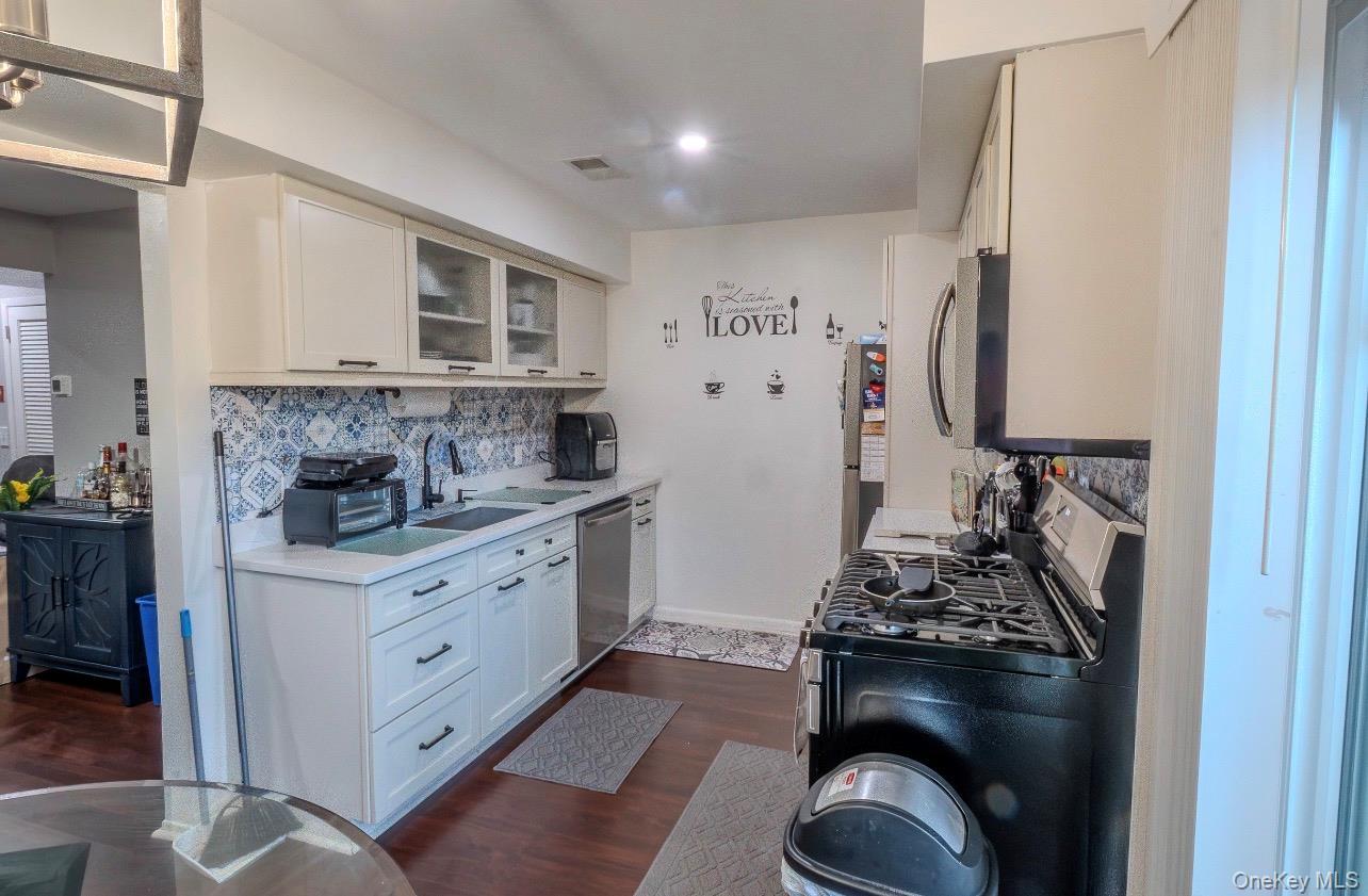 276 Temple Hill Road, Unit 704 New Windsor, NY 12553 - Photo 4 of 18 a kitchen with stainless steel appliances granite countertop a stove and a refrigerator