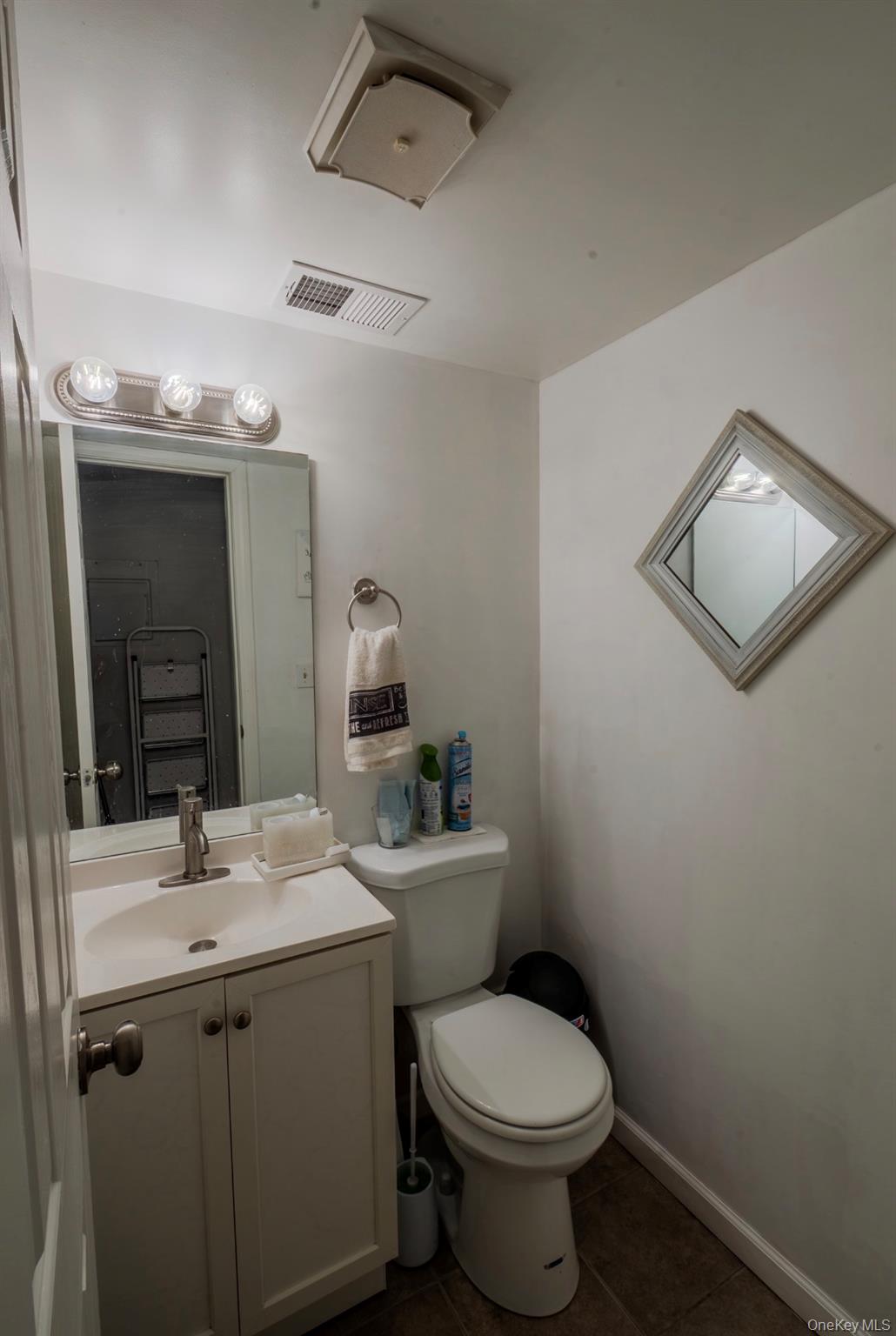 276 Temple Hill Road, Unit 704 New Windsor, NY 12553 - Photo 5 of 18 a bathroom with a toilet sink and mirror