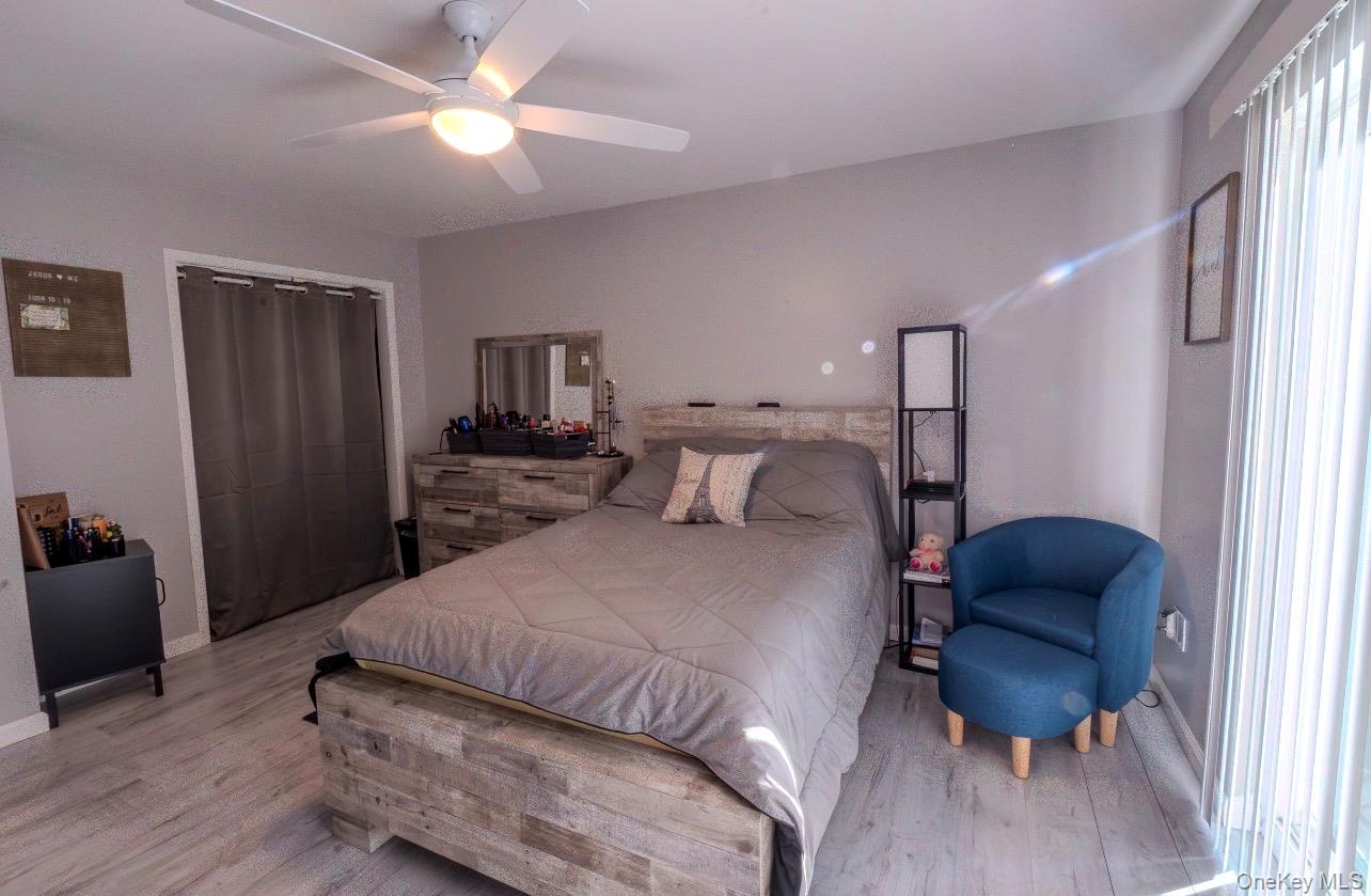 276 Temple Hill Road, Unit 704 New Windsor, NY 12553 - Photo 10 of 18 a bedroom with a bed and a chair