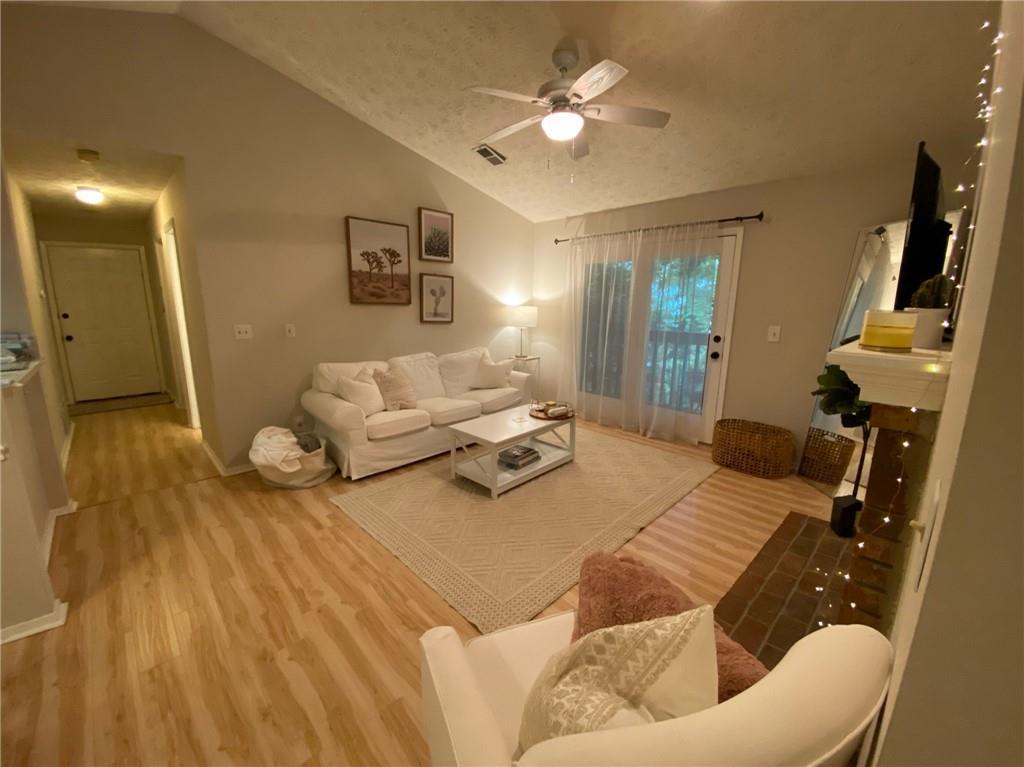 1212 McClelen Way, Unit 1212 Decatur, GA 30033 - Photo 1 of 1 a living room with furniture and a wooden floor