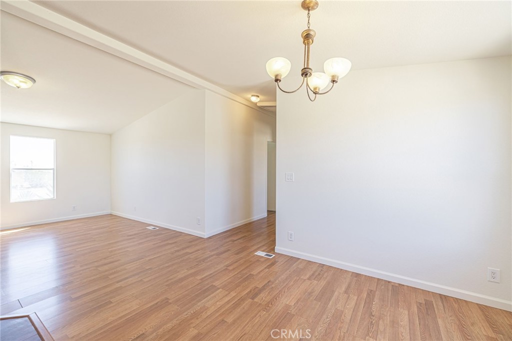 26321 Olanche Street Mojave, CA 93501 - Photo 11 of 39 an empty room with wooden floor and windows