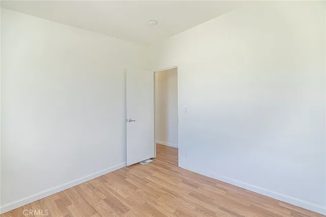 a bedroom with a large bed and a potted plant