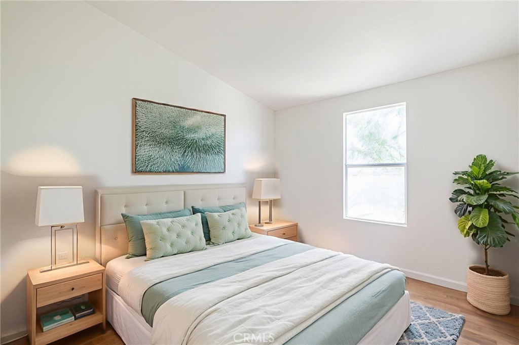 26321 Olanche Street Mojave, CA 93501 - Photo 28 of 39 a bedroom with a bed and a potted plant