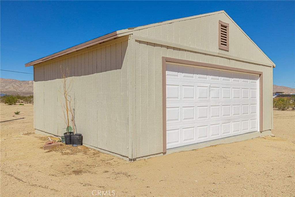 26321 Olanche Street Mojave, CA 93501 - Photo 34 of 39 a view of a house with wooden fence