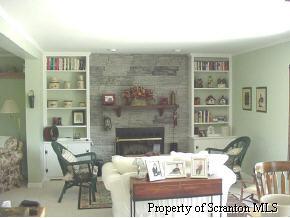 654 Rd Tunkhannock, PA 18657 - Photo 1 of 2 a view of a dining room with furniture wooden floor and a fireplace