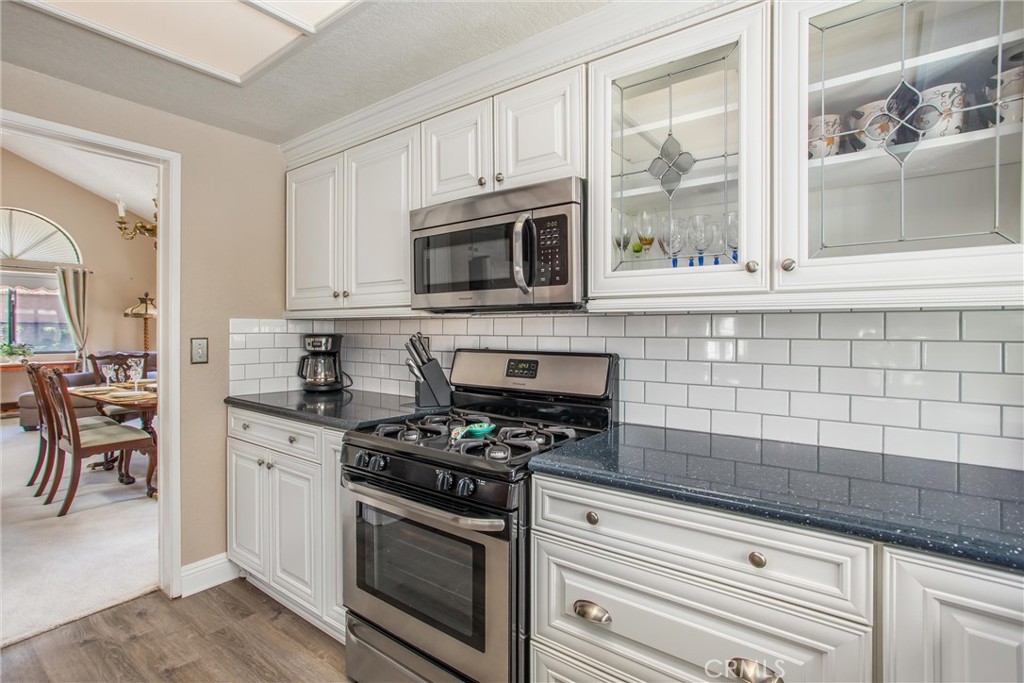 1125 Vía Nice Redlands, CA 92374 - Photo 12 of 50 a kitchen with cabinets stainless steel appliances and a window