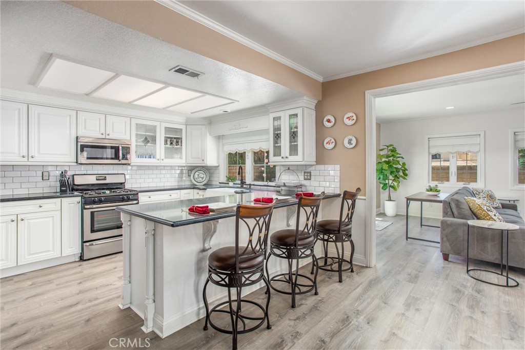 1125 Vía Nice Redlands, CA 92374 - Photo 14 of 50 a kitchen with microwave a stove and cabinets
