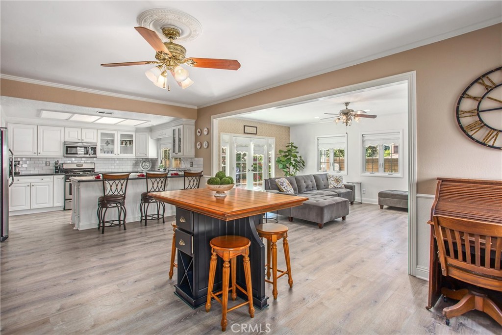 1125 Vía Nice Redlands, CA 92374 - Photo 18 of 50 a living room with furniture a dining table and chairs with wooden floor
