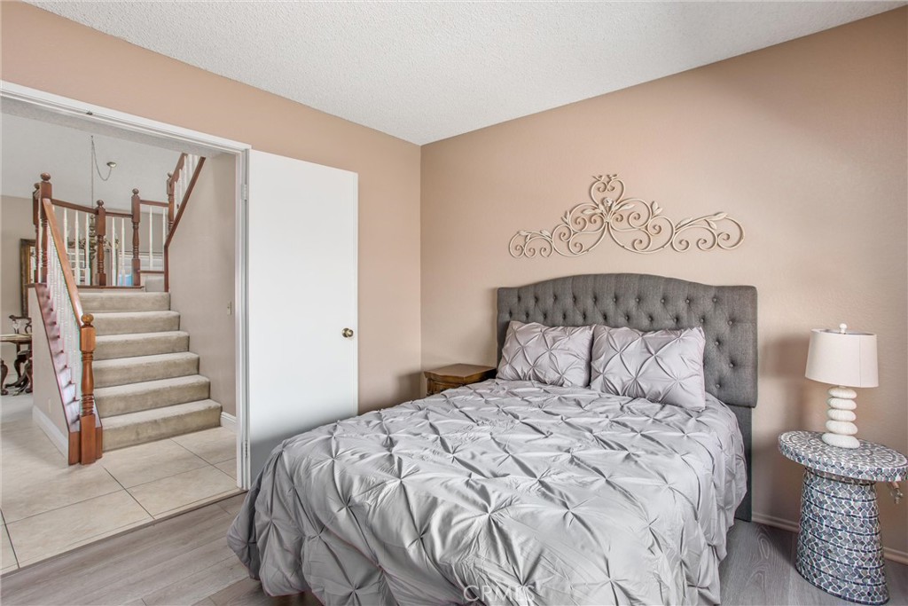 1125 Vía Nice Redlands, CA 92374 - Photo 24 of 50 a bedroom with a bed and wooden floor