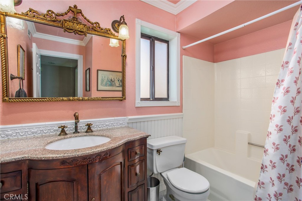 1125 Vía Nice Redlands, CA 92374 - Photo 25 of 50 a bathroom with a granite countertop sink toilet a mirror and shower