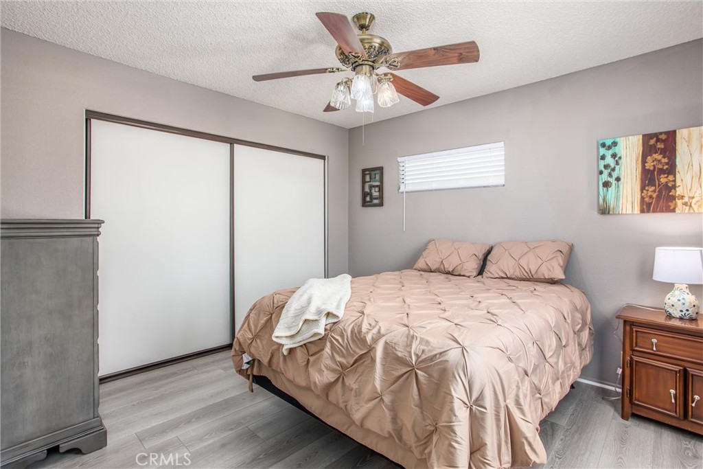 1125 Vía Nice Redlands, CA 92374 - Photo 28 of 50 a bedroom with a bed and a chandelier