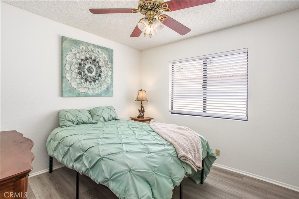 1125 Vía Nice Redlands, CA 92374 - Photo 32 of 50 a bedroom with a bed and a chandelier
