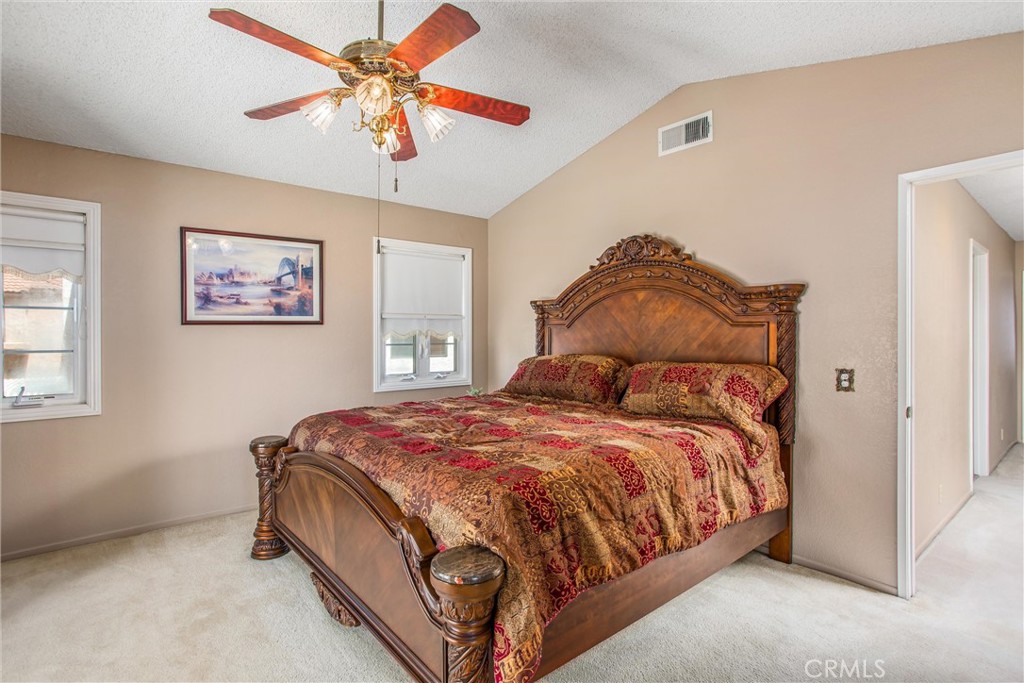 1125 Vía Nice Redlands, CA 92374 - Photo 35 of 50 a bedroom with a bed and a chandelier