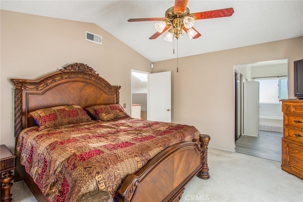 1125 Vía Nice Redlands, CA 92374 - Photo 36 of 50 a bedroom with a bed and a chandelier