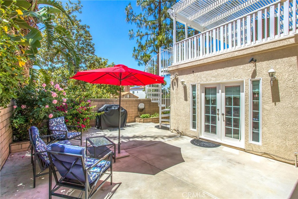 1125 Vía Nice Redlands, CA 92374 - Photo 43 of 50 a view of a patio with a table and chairs under an umbrella